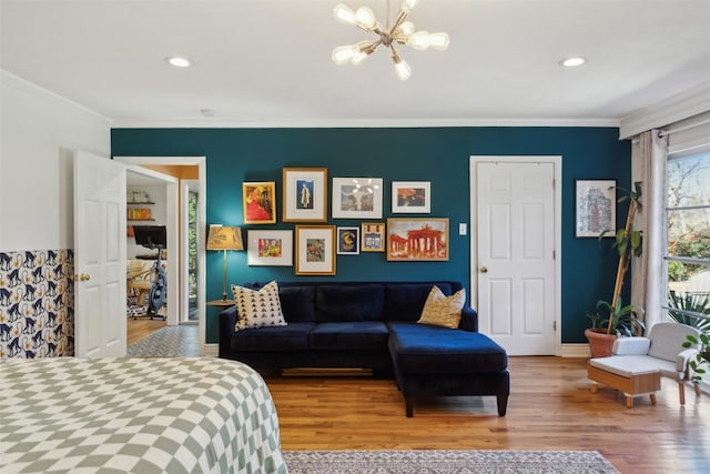 bedroom featuring an inviting chandelier, hardwood / wood-style flooring, and ornamental molding