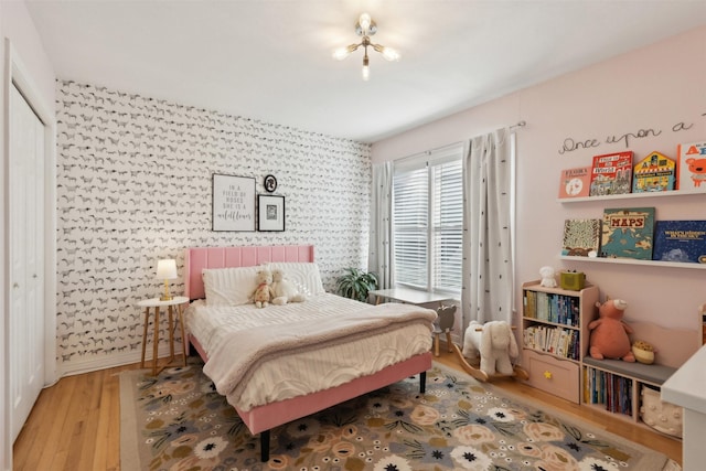 bedroom featuring baseboards and wood finished floors