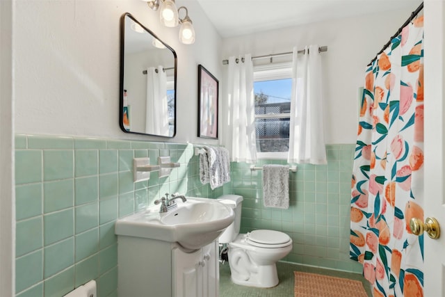 bathroom with tile patterned floors, toilet, tile walls, vanity, and a shower with shower curtain