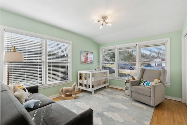 bedroom featuring hardwood / wood-style floors and vaulted ceiling