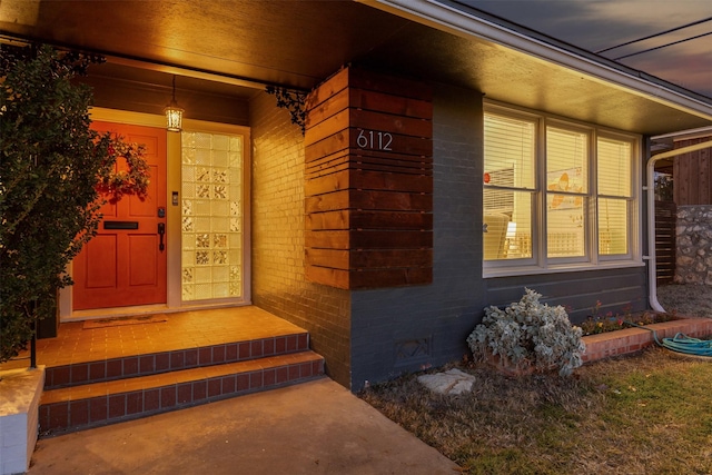 property entrance featuring brick siding