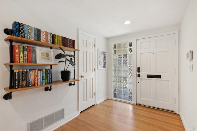 foyer entrance with light hardwood / wood-style floors