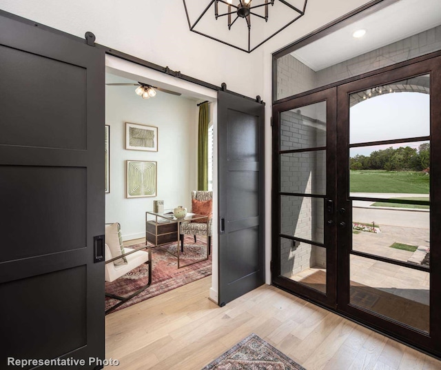 doorway to outside featuring light hardwood / wood-style floors and a barn door