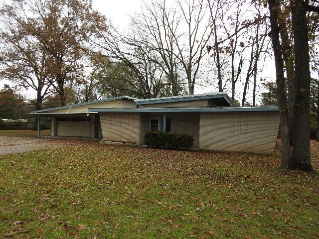 view of home's exterior featuring a garage and a yard