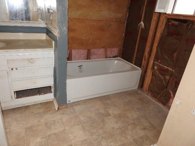 bathroom with a tub to relax in