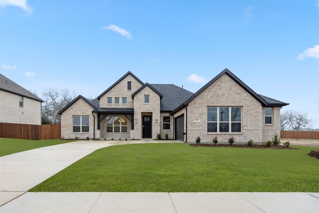 view of front of property featuring a yard and covered porch