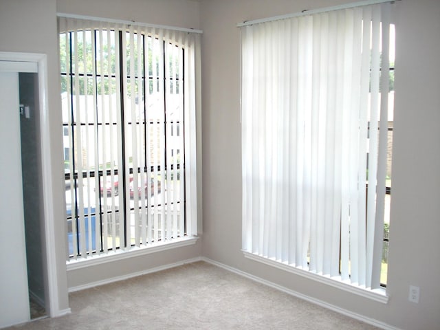 spare room featuring light colored carpet