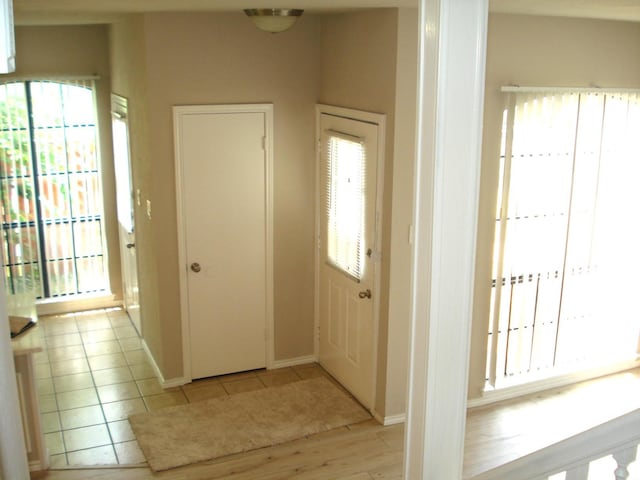 foyer entrance with plenty of natural light and light tile patterned floors