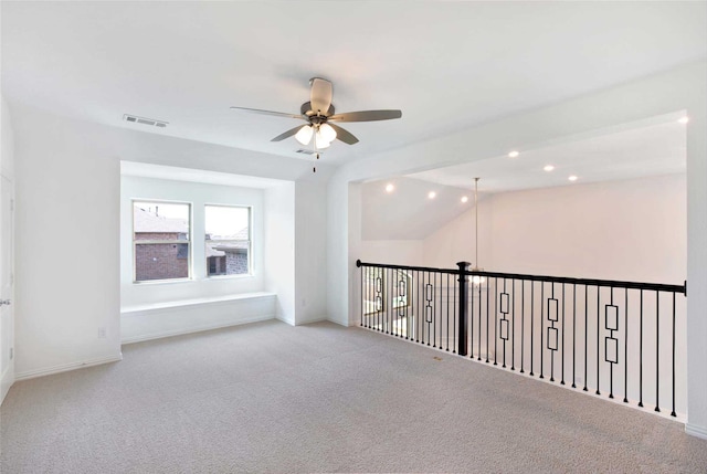 carpeted spare room with ceiling fan and lofted ceiling