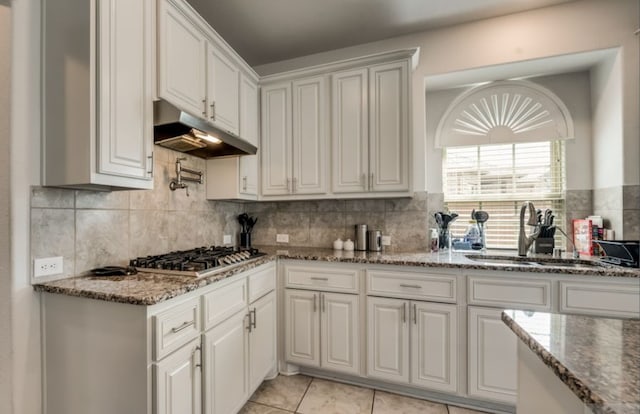 kitchen featuring sink, white cabinetry, tasteful backsplash, stone countertops, and stainless steel gas stovetop