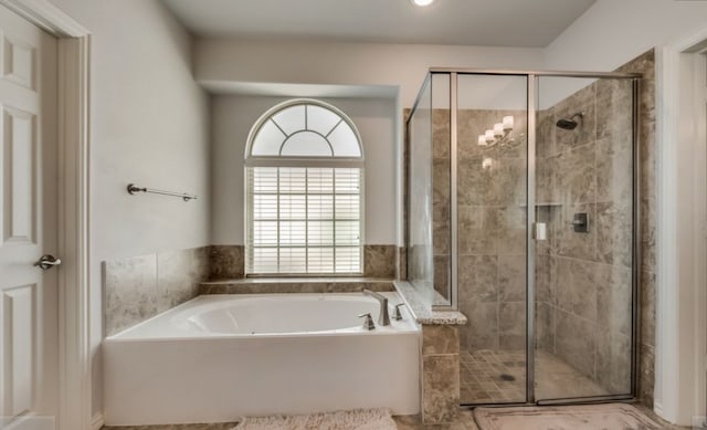 bathroom with shower with separate bathtub