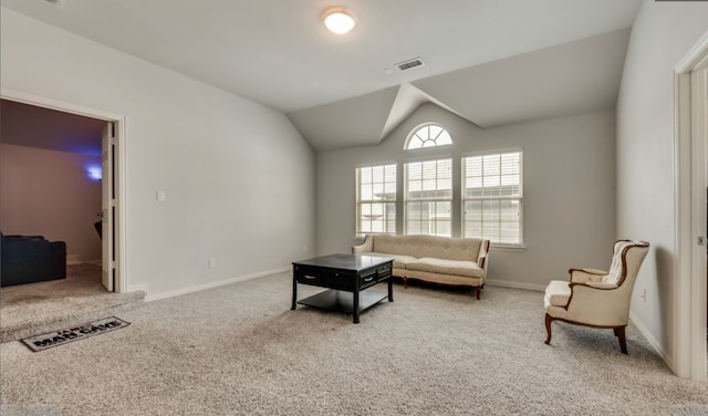 living area featuring lofted ceiling and carpet flooring