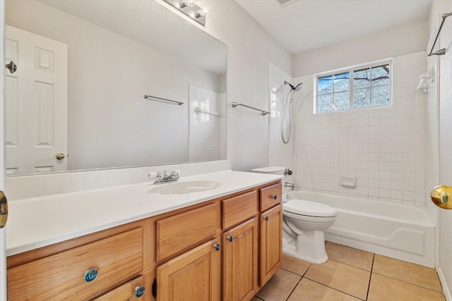 full bathroom featuring tiled shower / bath, vanity, toilet, and tile patterned flooring