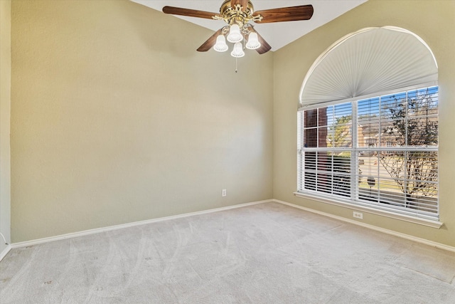 empty room featuring ceiling fan and light carpet