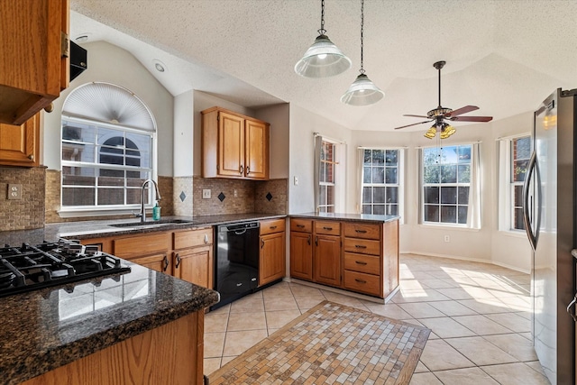 kitchen with light tile patterned flooring, lofted ceiling, stainless steel fridge, black dishwasher, and kitchen peninsula