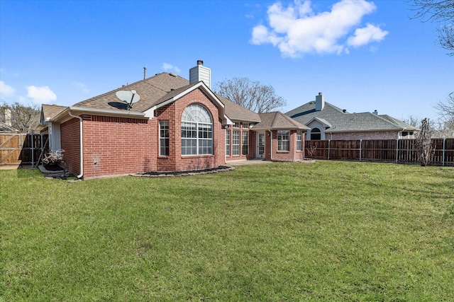 rear view of property featuring a yard