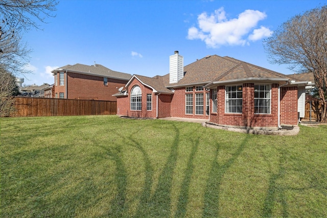 rear view of property featuring a yard