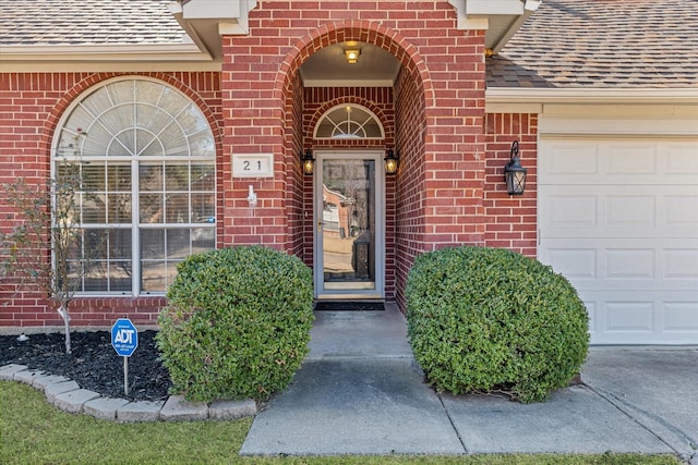 view of exterior entry with a garage