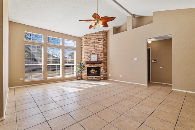 unfurnished living room with beamed ceiling, a stone fireplace, high vaulted ceiling, and light tile patterned floors