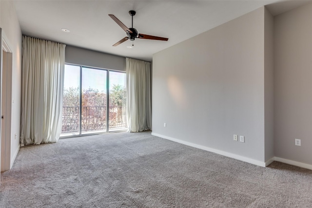 unfurnished room featuring ceiling fan and light carpet