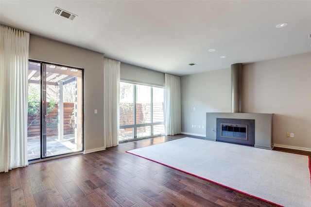 unfurnished living room with dark hardwood / wood-style floors