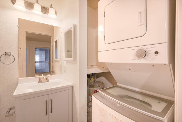 clothes washing area featuring sink and stacked washer and clothes dryer