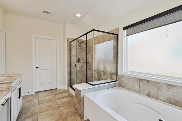 bathroom with vanity and separate shower and tub