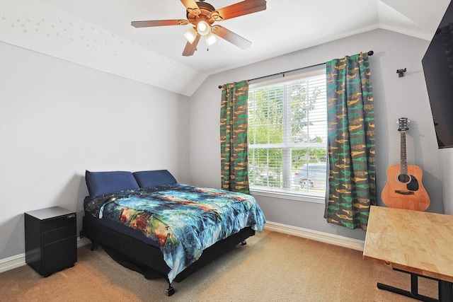 bedroom with multiple windows, vaulted ceiling, carpet floors, and ceiling fan