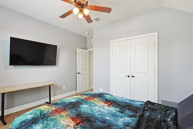 bedroom with vaulted ceiling, a closet, and ceiling fan