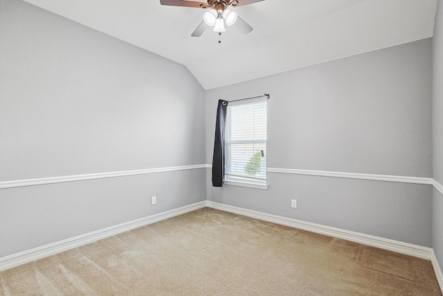 carpeted empty room featuring vaulted ceiling and ceiling fan