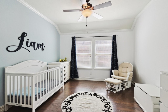 bedroom with lofted ceiling, crown molding, a crib, ceiling fan, and dark hardwood / wood-style floors