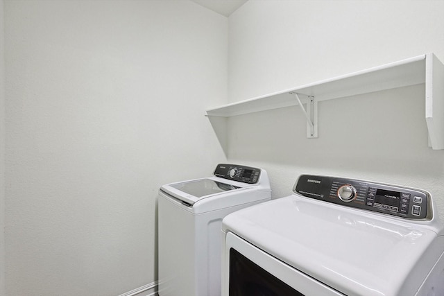 washroom featuring washer and clothes dryer