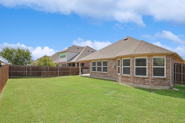 rear view of property featuring a lawn