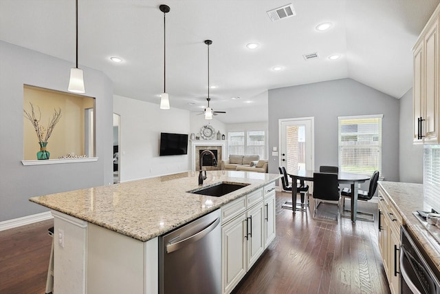 kitchen featuring decorative light fixtures, an island with sink, sink, dark hardwood / wood-style flooring, and stainless steel appliances