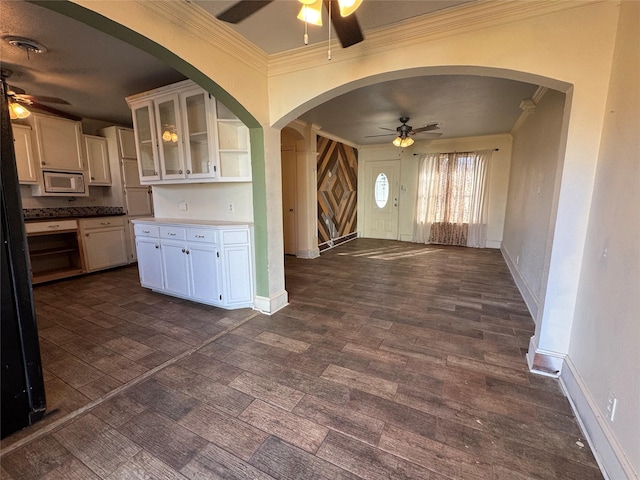 kitchen featuring white cabinets, crown molding, dark hardwood / wood-style floors, and white microwave