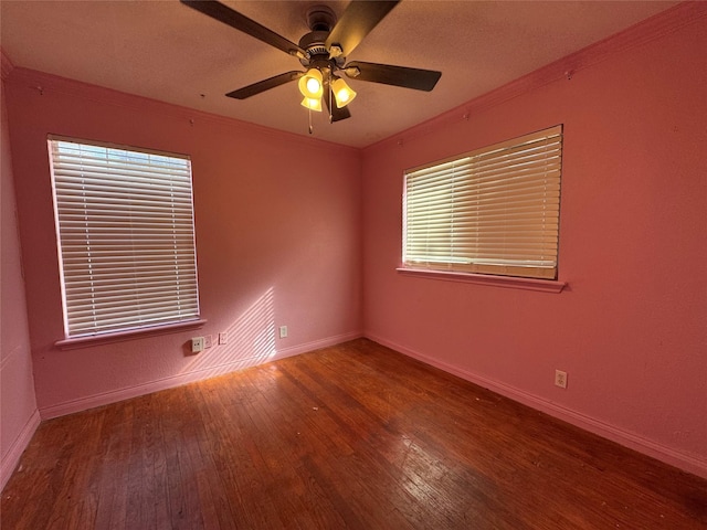 spare room with wood-type flooring, ornamental molding, and ceiling fan