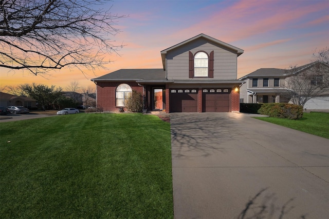 view of front of property featuring a garage and a lawn