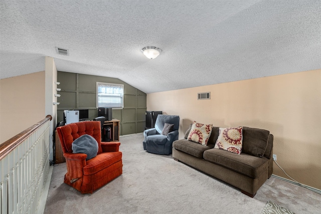 living room with carpet floors, vaulted ceiling, and a textured ceiling