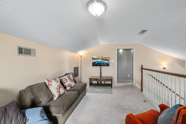 carpeted living room featuring lofted ceiling and a textured ceiling