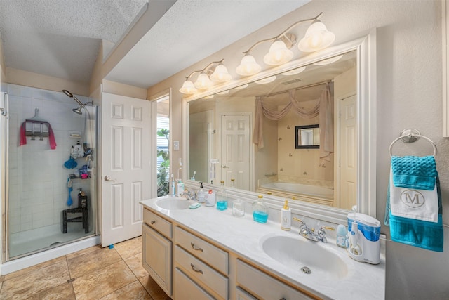 bathroom with independent shower and bath, vanity, tile patterned floors, and a textured ceiling