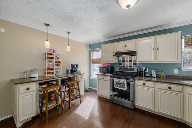 kitchen featuring crown molding, stainless steel appliances, dark hardwood / wood-style floors, and cream cabinetry