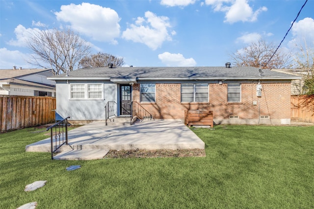 rear view of house with brick siding, a yard, fence private yard, and a patio