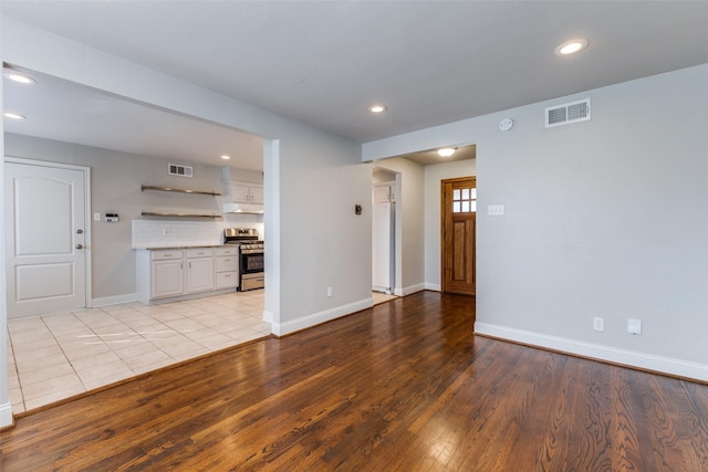 unfurnished living room featuring recessed lighting, visible vents, and light wood finished floors