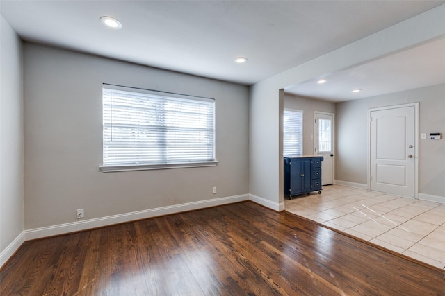 unfurnished room featuring recessed lighting, light wood-type flooring, and baseboards