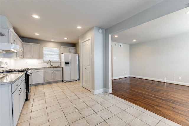 kitchen featuring recessed lighting, white appliances, tasteful backsplash, and light tile patterned flooring