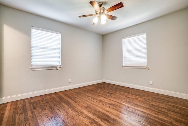 empty room featuring wood finished floors, a healthy amount of sunlight, baseboards, and ceiling fan