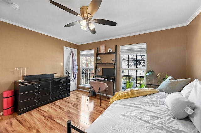 bedroom with wood-type flooring, ornamental molding, and ceiling fan