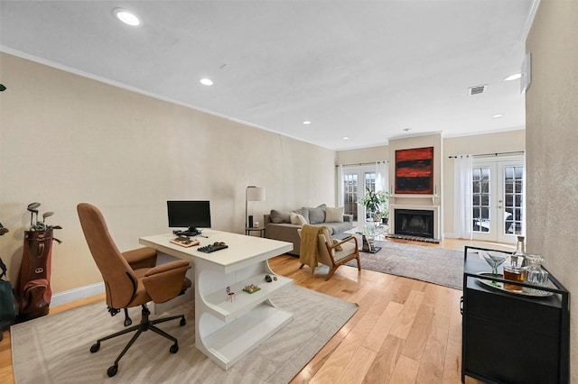 office space with ornamental molding, light hardwood / wood-style flooring, and french doors