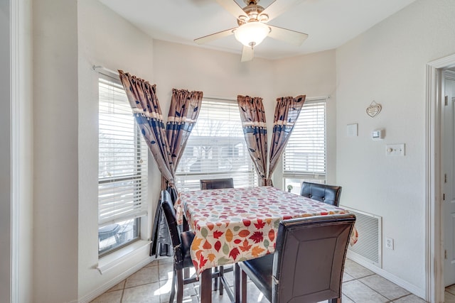 tiled dining space with ceiling fan