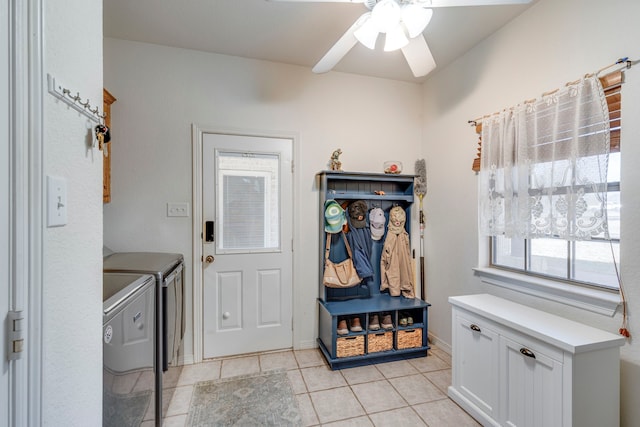 mudroom with ceiling fan, separate washer and dryer, and light tile patterned floors